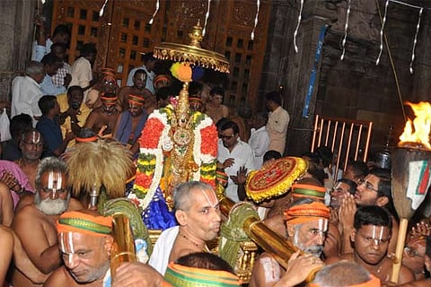 Lord Namperumal being brought in a gold palanquin at Srirangam on Friday