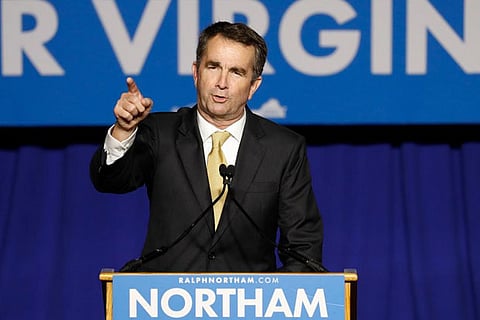 Virginia governor says he will stay in job, denies being in racist yearbook photo