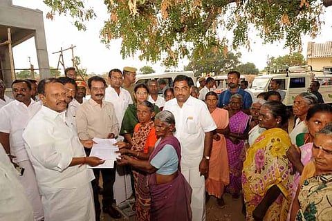 LS Deputy Speaker M Thambidurai recieves a petition from a senior citizen at Seethapatti Colony in Karur