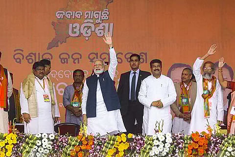PM Modi waves to his Party supporters and workers during 'Jabab Maguchhi Odisha' at Baripada