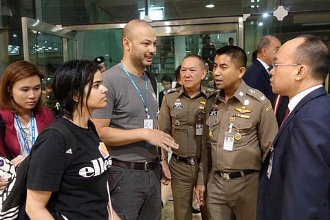 Saudi teen Rahaf Mohammed al-Qunun is seen with Thai immigration authorities at Suvarnabhumi Airport