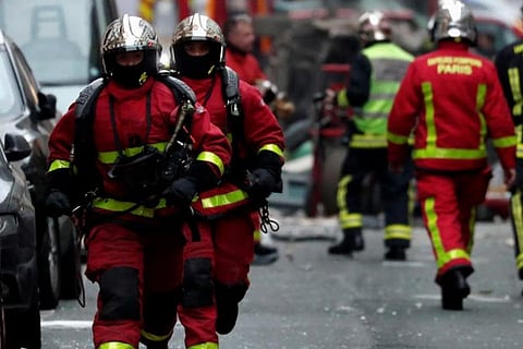 Firemen work at the site of an explosion in a bakery shop in the 9th District in Paris, France
