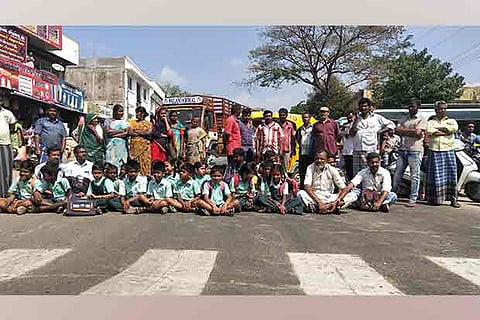 Parents of children studying at the Panchayat Union Primary School block the Pollachi-Anamalai Road on Monday