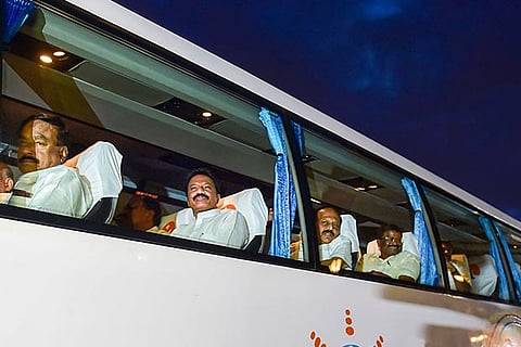 A bus, carrying JDS MLAs, leaves from Taj West End hotel