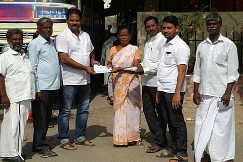 Suresh Kumar distributing pamphlets with details of water supplied by the Municipality