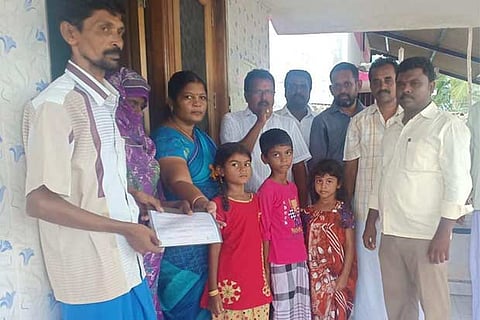 The bond paper being presented to Afra as others look on