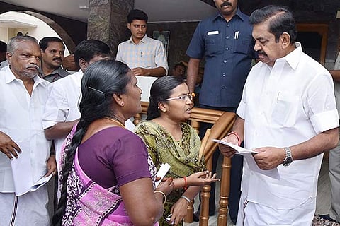 Chief Minister Edappadi K Palaniswami receives a petition from a differently abled girl in Salem district