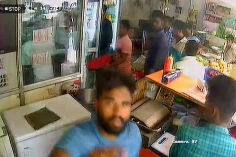 A suspect trying to cover CCTV camera