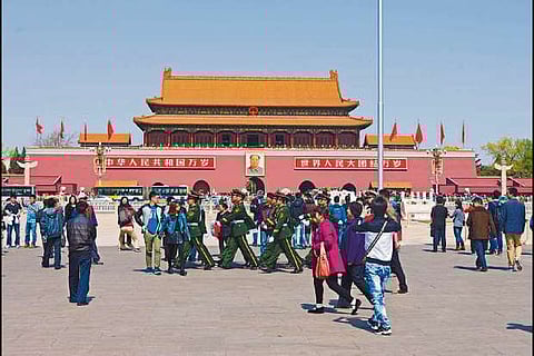 Soliders marching through crowd at north end of Tiananmen Square