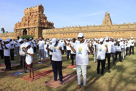 Students performing yoga at Brihadeeswara temple in Thanjavur on Thursday