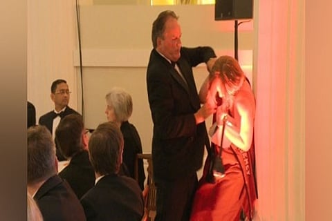 British minister suspended for manhandling protester