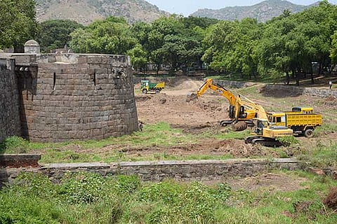 Weed clearing work in progress around the moat of the Vellore fort
