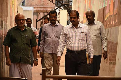 Idol wing police officials come out of the library on Wednesday, after questioning its former and serving emp