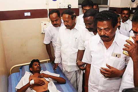 AIADMK?s Karur candidate M Thambidurai visits one of the injured party cadres at the government hospital