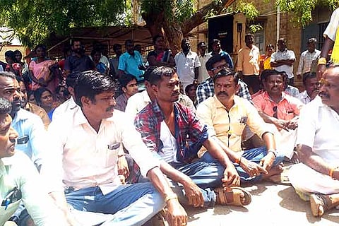 Agitated teachers and Revenue officials stage a stir at Government Arts College in Sivaganga on Saturday