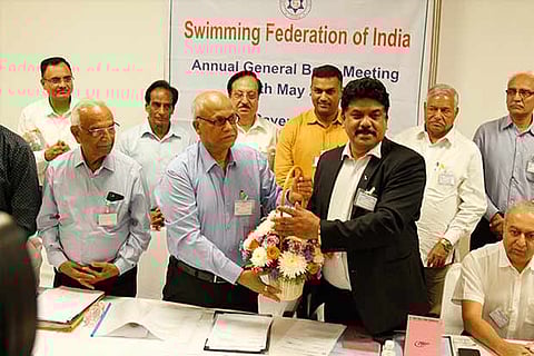 Outgoing President of SFI Dhigambar Kamath (left) greeting newly-elected chief RN Jayaprakash