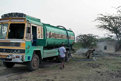 A private water lorry collecting water from a farm well