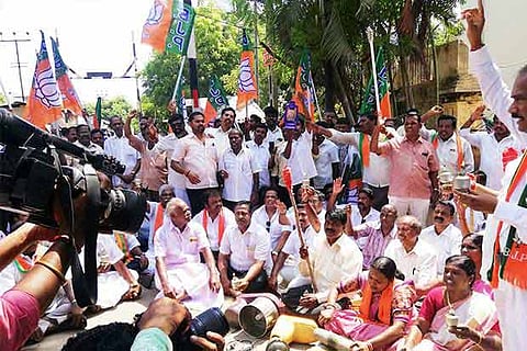 BJP workers stage a protest against hike in power tariff in Puducherry on Monday