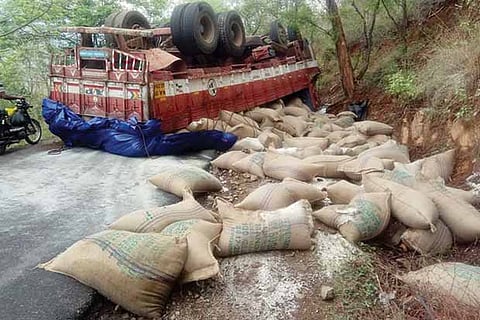 Sugar sacks lay strewn near the lorry that capsized on the  ghat road in Bargur on Tuesday