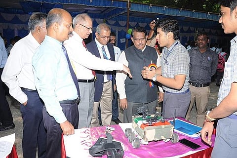 A student explains the mechanism of a project model at the science exhibition on Monday