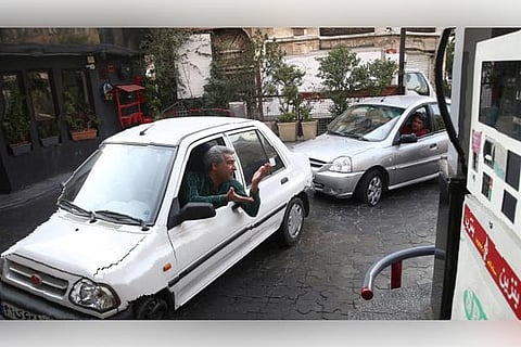 Cars queue at a petrol station