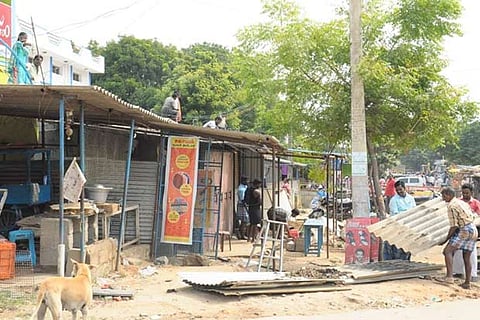 Demolition drive under way along the highway in Tiruttani on Thursday