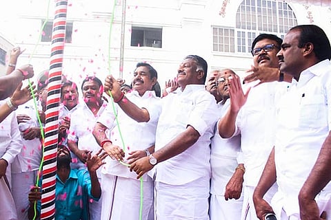 AIADMK coordinator and Deputy Chief Minister O Panneerselvam hoisting the party flag on founding day