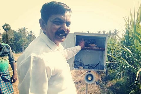 Farmer Raja with his device