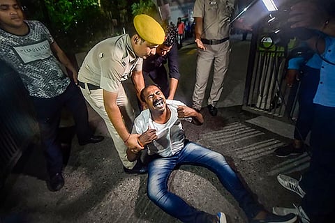 DK Shivakumar's supporter cries as he is dragged away by police personnel outside RML Hospital | PTI