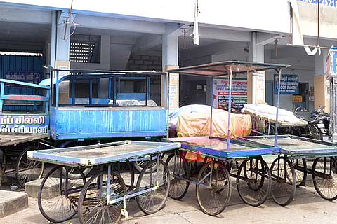 Two-wheelers and push-carts parked in the Vellore bus stand cloak room area