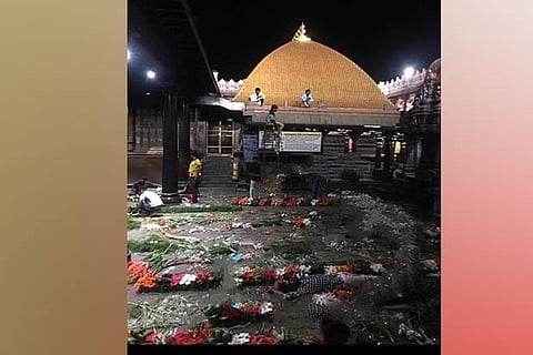 Workers atop the golden dome of Chidambaram Natarajar temple to decorate it for a marriage on Friday