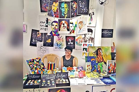An artist showcasing her sketches and works at the flea market