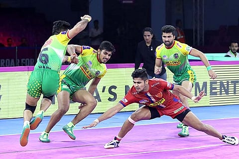 Delhi raider Naveen Kumar (in red) was his side?s second highest scorer