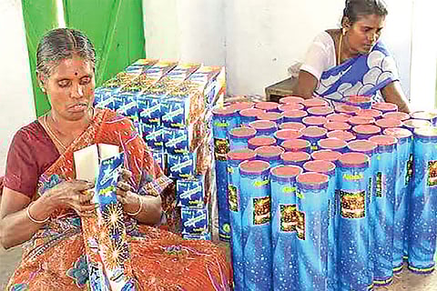 Women workers engaged in packing crackers at a unit in Sivakasi