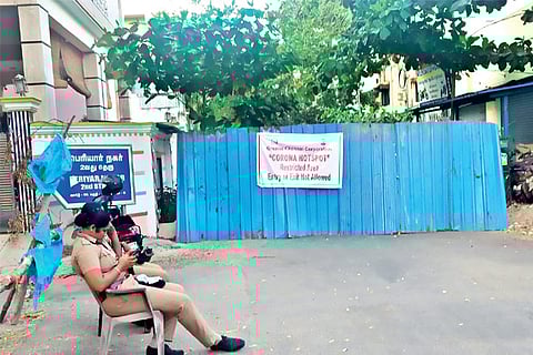 A corona hotspot banner is stuck on the barricades put up at the sealed Chandrasekaran Street