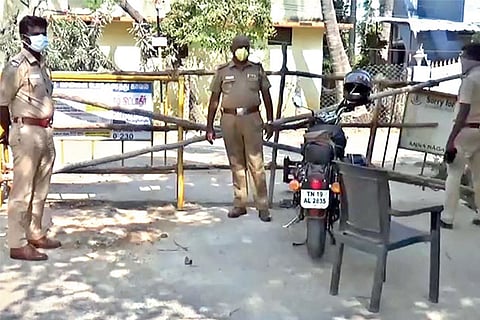 Police personnel guard one of the barricaded entrances to Sembakkam municipality in city?s suburbs