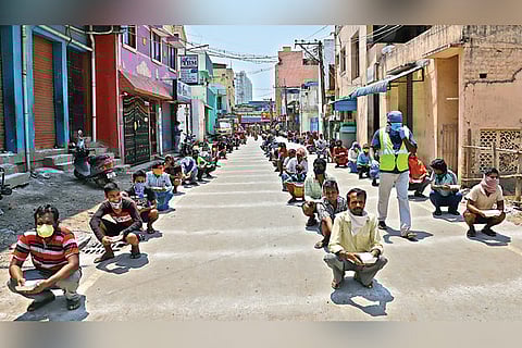 Migrant workers queue up for food at Ambattur