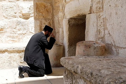 Holy Fire lit as Orthodox Easter bells echo over near-empty Jerusalem