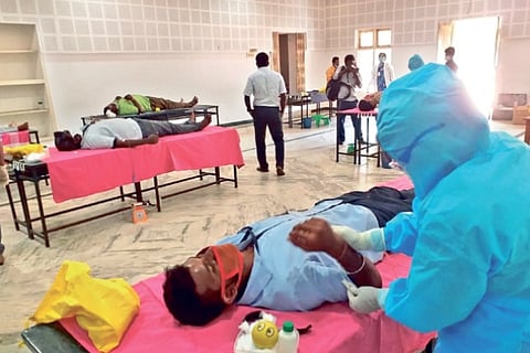 Volunteers donating blood at a special camp in Tiruchy on Monday