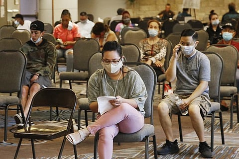 People wait to speak with representatives from the Oklahoma Employment Security Commission