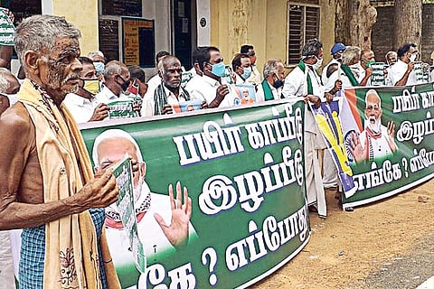 Farmers staging protest with charcoal on their faces near Tiruvaiyaru on Wednesday