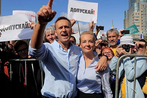 Russian opposition leader Aleksei Navalny seen with his wife at a rally in 2019