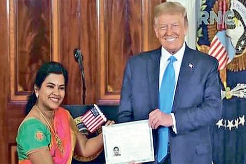 Sudha Sundari Narayanan being handed the certificate of citizenship by Trump