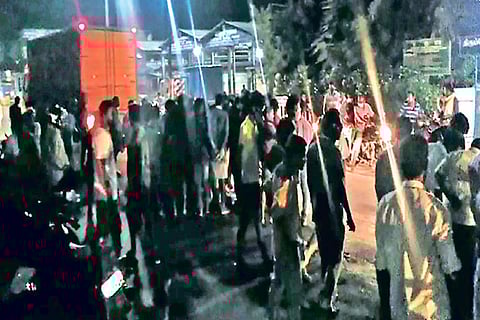 Police, residents gather after a bomb blasted