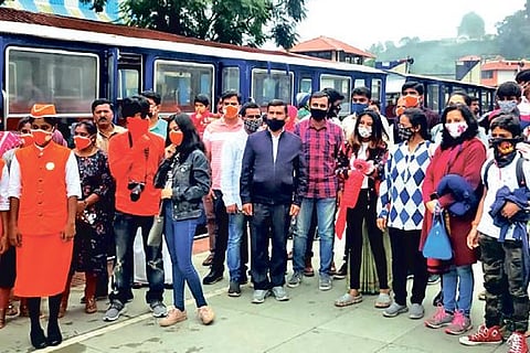Tourists assemble to board the train.
