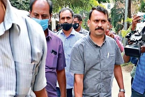 Officials leave with trunks after a raid in Valasaravakkam