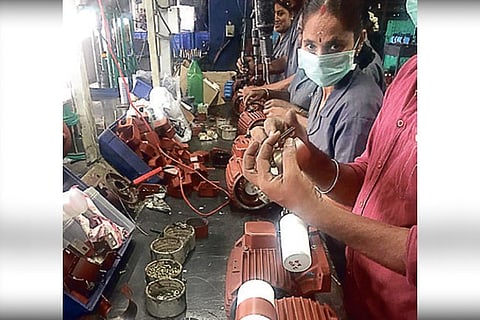 Workers at a pump manufacturing unit.