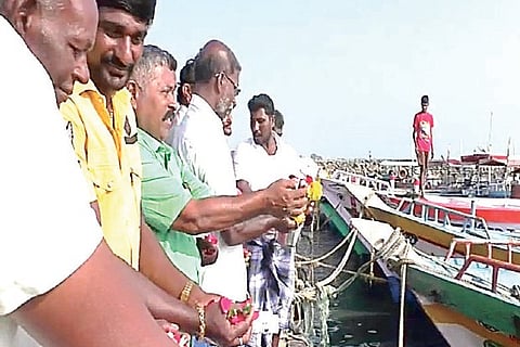 Fishermen shower petals at Threspuram in Thoothukudi on Saturday to mark the anniversary of Tsunami