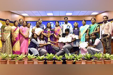 Students receive the trophy from the chief guest at the event