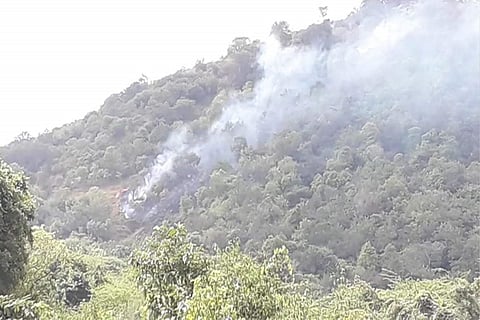 Smoke from burning vegetation on the hill